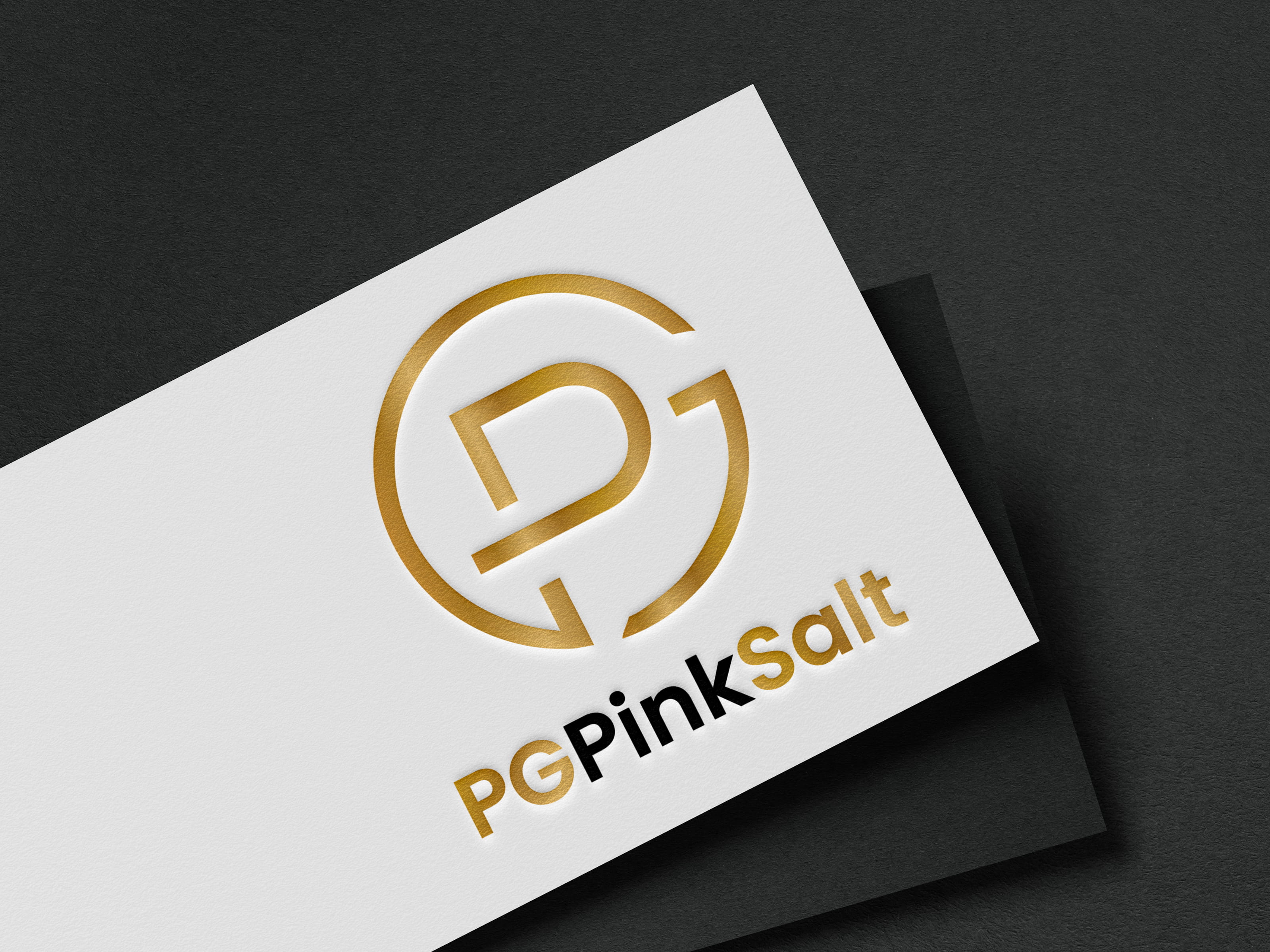Premium PG Pink Salt logo mockup embossed in gold on a white business card, showcasing elegant branding for a Himalayan pink salt and natural food products company.